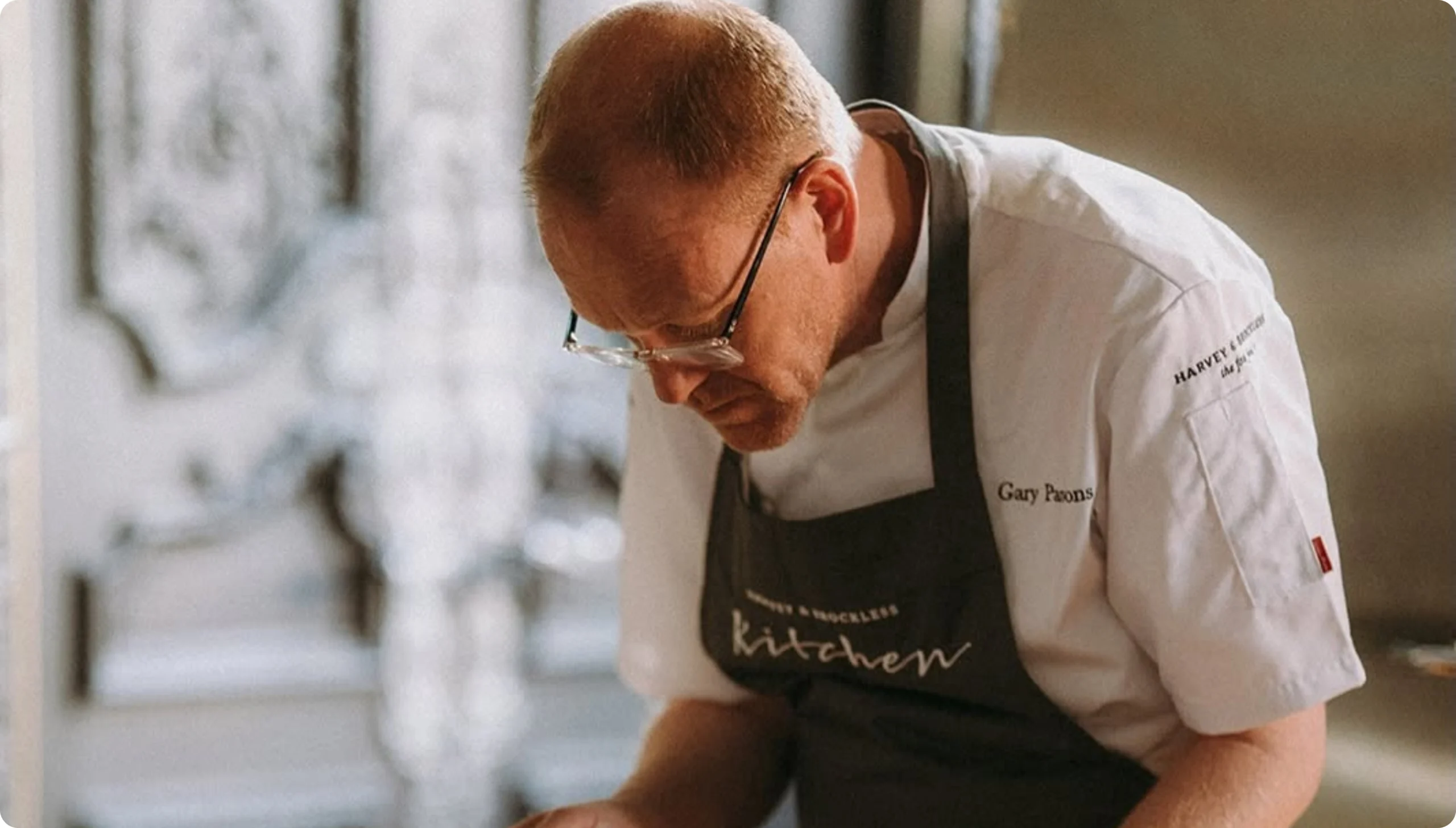 Chef preparing food in a commercial kitchen for Harvey & Brockless